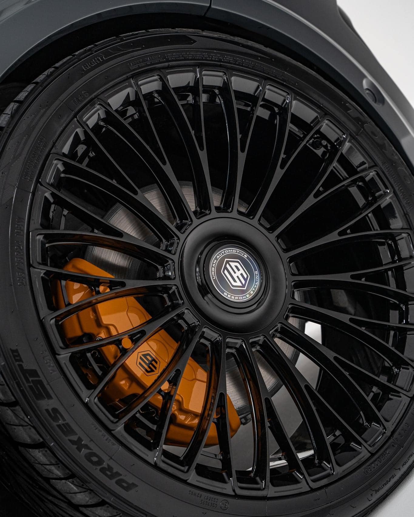 Black Urban alloy wheels with orange brake calipers in Ireland