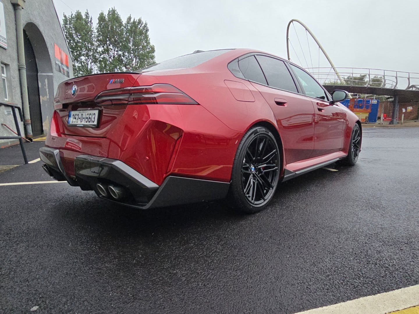 Rear side view of red BMW M5 in Ireland